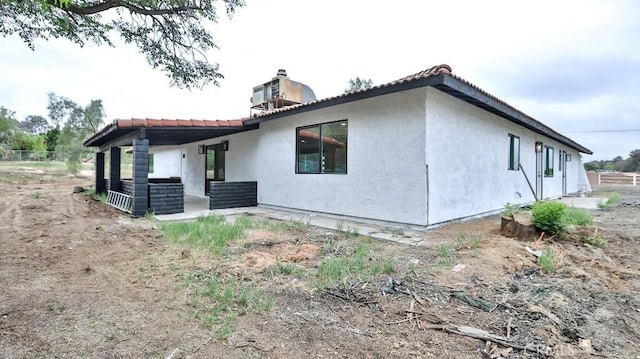 18971 Birch St, Perris, CA 92570 - view of property exterior with stucco siding, central AC, and a patio