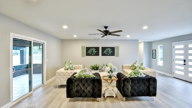 living area with recessed lighting, plenty of natural light, and light wood finished floors