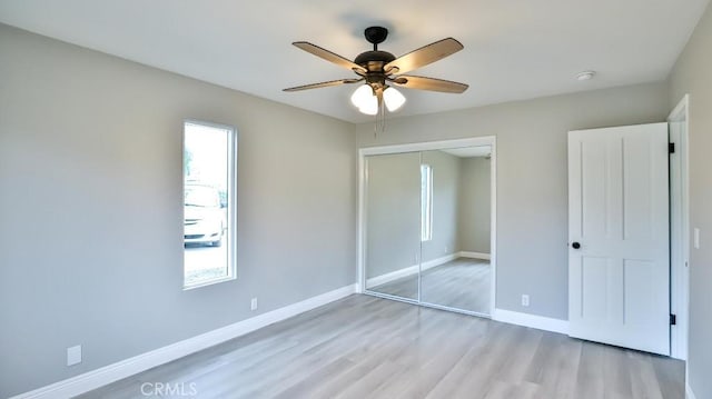 18971 Birch St, Perris, CA 92570 - unfurnished bedroom featuring light wood-style floors, a closet, baseboards, and a ceiling fan