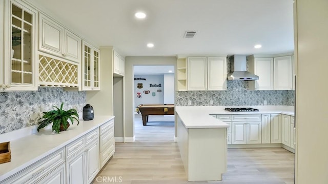 18971 Birch St, Perris, CA 92570 - kitchen featuring wall chimney exhaust hood, light wood-style flooring, backsplash, and recessed lighting