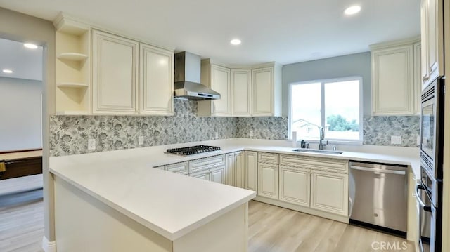 18971 Birch St, Perris, CA 92570 - kitchen with wall chimney range hood, a sink, stainless steel appliances, light wood-type flooring, and a peninsula