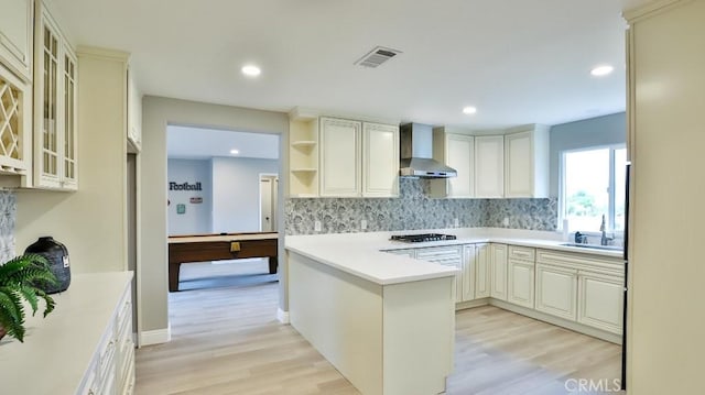 18971 Birch St, Perris, CA 92570 - kitchen with wall chimney exhaust hood, gas stovetop, tasteful backsplash, light wood-style floors, and recessed lighting