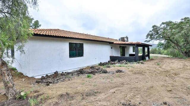 18971 Birch St, Perris, CA 92570 - back of property with stucco siding, a tiled roof, and central air condition unit