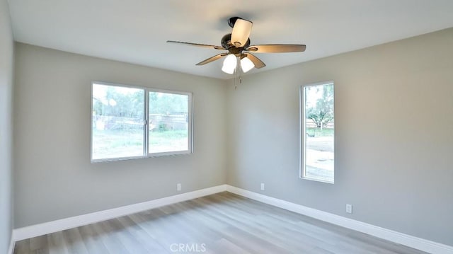 18971 Birch St, Perris, CA 92570 - unfurnished room featuring plenty of natural light, wood finished floors, baseboards, and ceiling fan