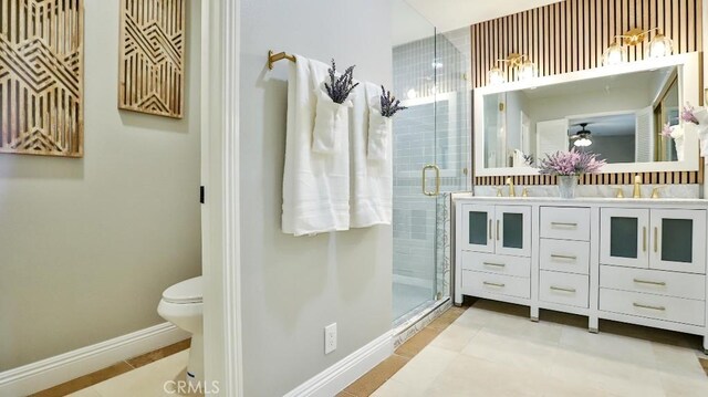 18971 Birch St, Perris, CA 92570 - bathroom featuring a shower stall, double vanity, baseboards, tile patterned flooring, and toilet