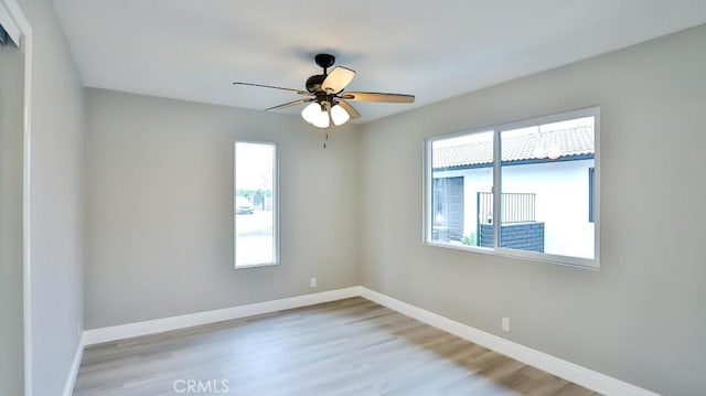 18971 Birch St, Perris, CA 92570 - empty room with healthy amount of natural light, wood finished floors, baseboards, and ceiling fan