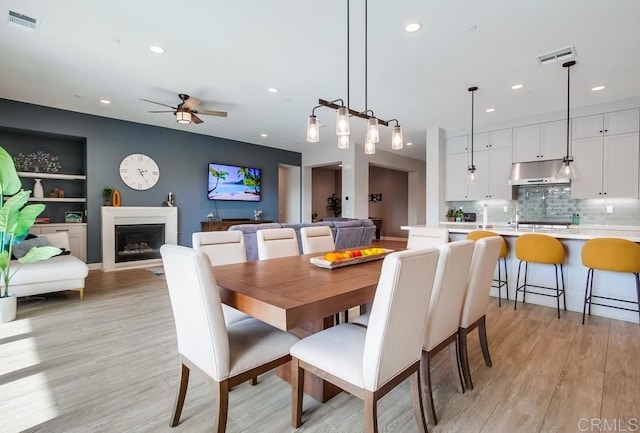 1221 Gable Ct, San Marcos, CA 92069 - dining space with recessed lighting, ceiling fan, light wood-style floors, and a fireplace