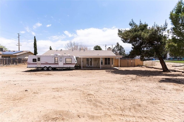 9018 Buckthorn Ave, Hesperia, CA 92345 - rear view of house with a chimney, fence, and french doors