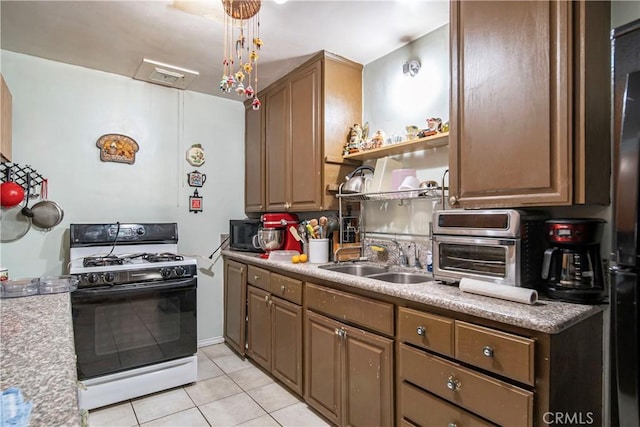 490 Crosby St, Altadena, CA 91001 - kitchen with range with gas stovetop, open shelves, a sink, light tile patterned flooring, and a toaster