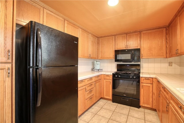 1268 Baden Ave, Grover Beach, CA 93433 - kitchen featuring light tile patterned flooring, tasteful backsplash, tile countertops, and black appliances
