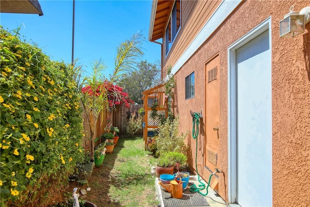 1268 Baden Ave, Grover Beach, CA 93433 - view of side of home with a fenced backyard and stucco siding