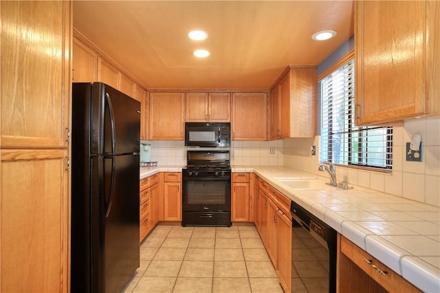 1268 Baden Ave, Grover Beach, CA 93433 - kitchen featuring tile countertops, light tile patterned floors, a sink, decorative backsplash, and black appliances