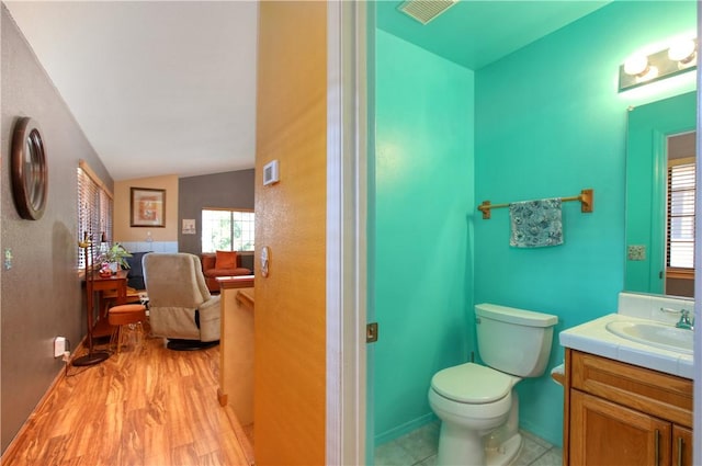 1268 Baden Ave, Grover Beach, CA 93433 - bathroom with vaulted ceiling, wood finished floors, vanity, and toilet