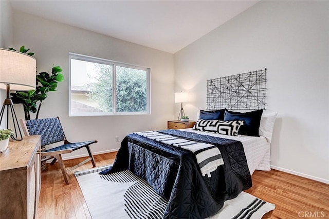 bedroom featuring light wood-type flooring and baseboards