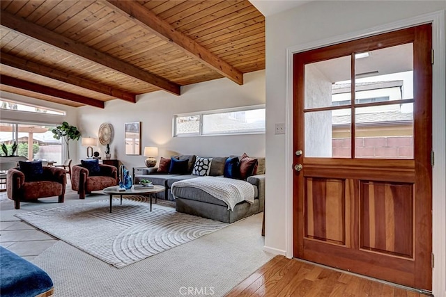 living room featuring light wood finished floors, plenty of natural light, vaulted ceiling with beams, and wooden ceiling