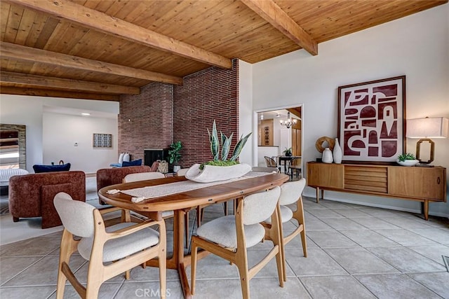 dining room featuring wooden ceiling, light tile patterned flooring, and beam ceiling
