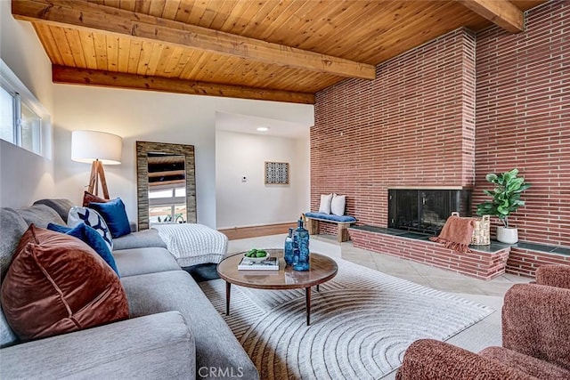 tiled living room featuring beamed ceiling, a fireplace, wooden ceiling, and brick wall