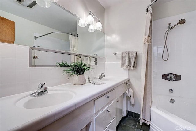 full bathroom with shower / bath combination with curtain, double vanity, tile patterned flooring, and a sink