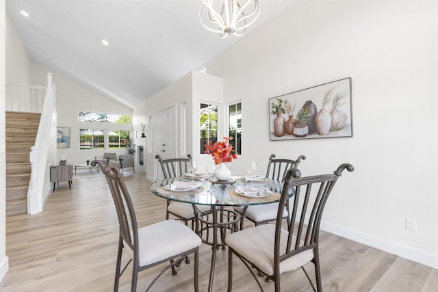 1194 Erin Dr, El Cajon, CA 92020 - dining space with high vaulted ceiling, light wood-type flooring, baseboards, stairs, and a notable chandelier