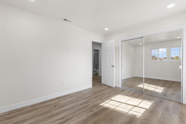 1194 Erin Dr, El Cajon, CA 92020 - unfurnished bedroom featuring baseboards, visible vents, recessed lighting, wood finished floors, and a closet