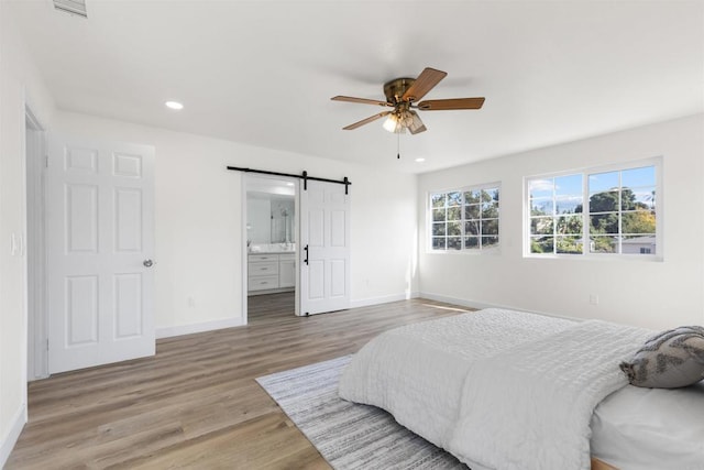 1194 Erin Dr, El Cajon, CA 92020 - bedroom featuring a barn door, baseboards, wood finished floors, and recessed lighting