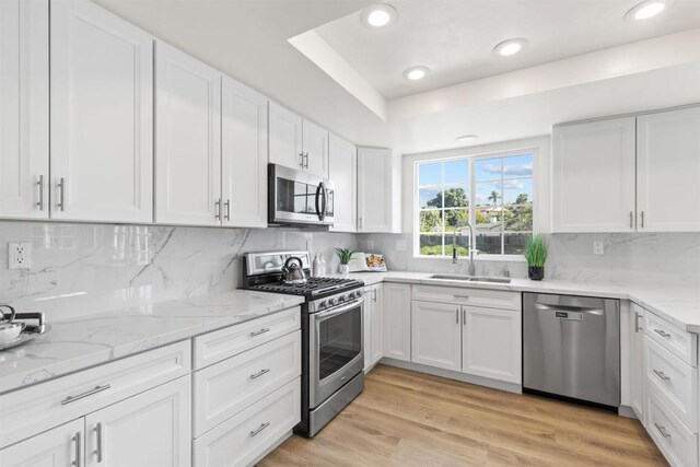 1194 Erin Dr, El Cajon, CA 92020 - kitchen with tasteful backsplash, a sink, stainless steel appliances, white cabinetry, and light stone countertops