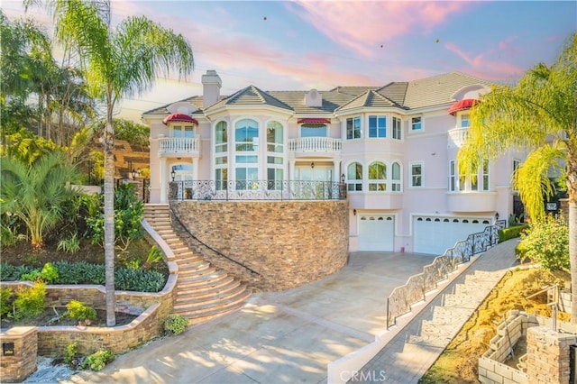 3499 Viewfield Ave, Hacienda Heights, CA 91745 - view of front facade with a chimney, stucco siding, concrete driveway, a tile roof, and a garage