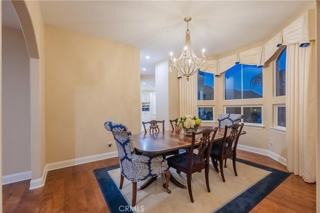3499 Viewfield Ave, Hacienda Heights, CA 91745 - dining area with baseboards, arched walkways, wood finished floors, and an inviting chandelier