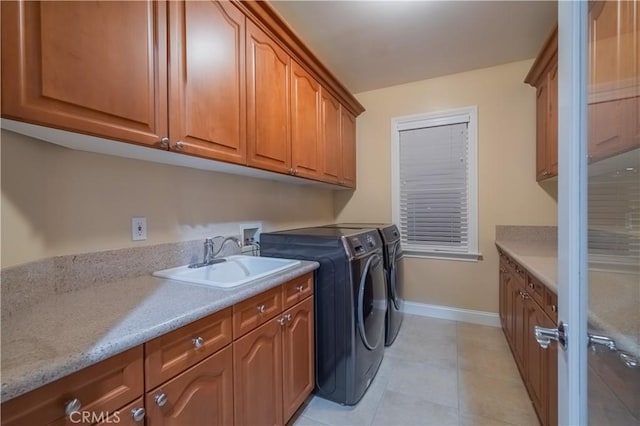 3499 Viewfield Ave, Hacienda Heights, CA 91745 - clothes washing area featuring washer and clothes dryer, a sink, light tile patterned floors, cabinet space, and baseboards