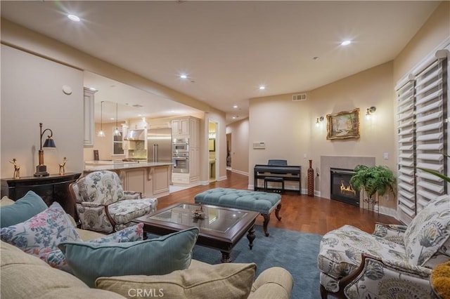3499 Viewfield Ave, Hacienda Heights, CA 91745 - living room with recessed lighting, wood finished floors, visible vents, baseboards, and a glass covered fireplace