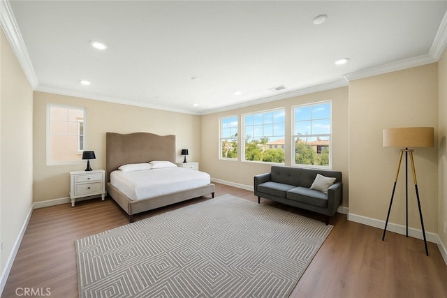 bedroom with wood finished floors, visible vents, and baseboards