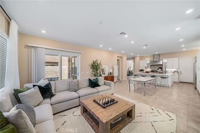 living room featuring light tile patterned floors, recessed lighting, and visible vents