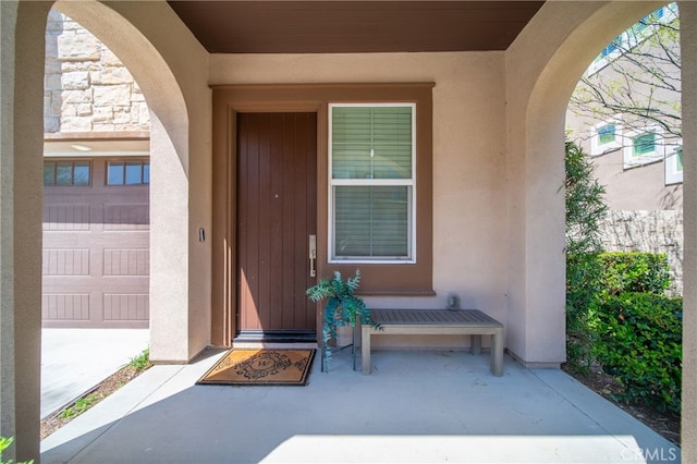entrance to property featuring stucco siding