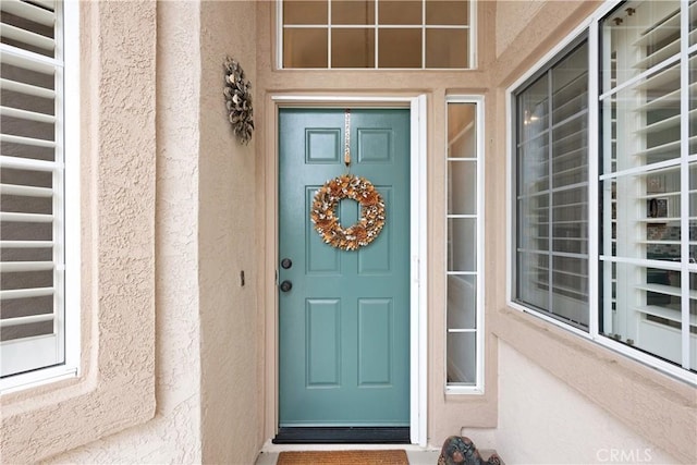 doorway to property with stucco siding