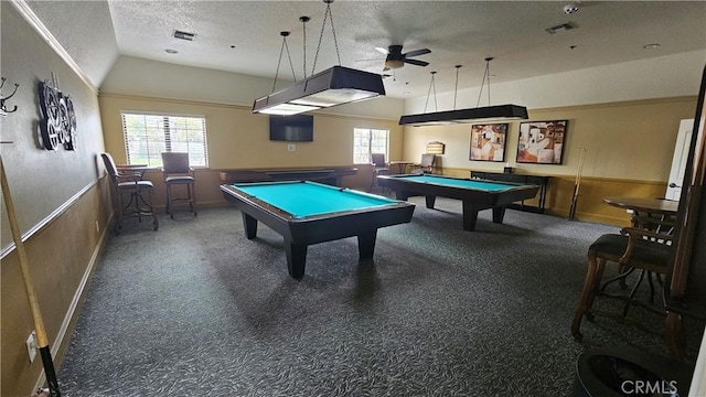 rec room featuring a textured ceiling, ceiling fan, visible vents, vaulted ceiling, and billiards