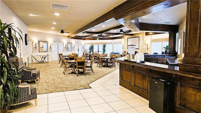 interior space with visible vents, light carpet, ceiling fan, and light tile patterned flooring