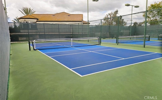view of tennis court with fence