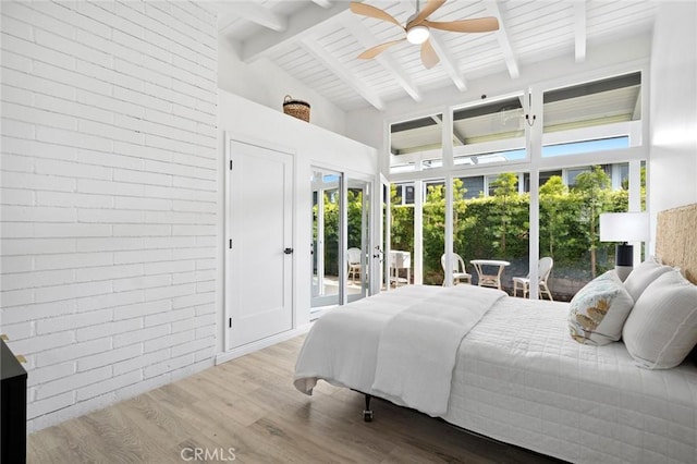 432 Seville Ave, Newport Beach, CA 92661 - bedroom featuring access to exterior, beamed ceiling, brick wall, wood finished floors, and high vaulted ceiling