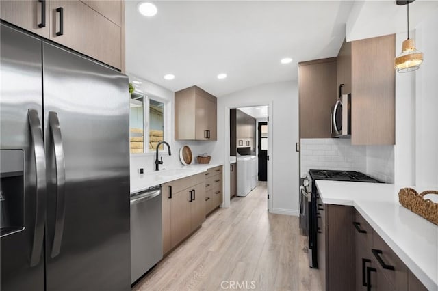 432 Seville Ave, Newport Beach, CA 92661 - kitchen with stainless steel appliances, light wood-style flooring, a sink, tasteful backsplash, and light countertops