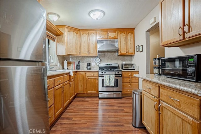 791 W 2nd St, San Pedro, CA 90731 - kitchen with appliances with stainless steel finishes, extractor fan, dark wood-style flooring, backsplash, and a sink