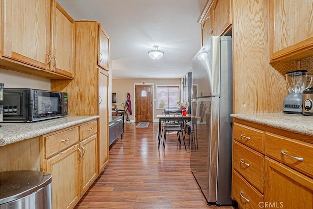 791 W 2nd St, San Pedro, CA 90731 - kitchen with freestanding refrigerator, wood finished floors, black microwave, and light brown cabinets