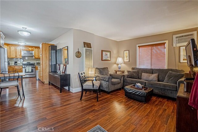 791 W 2nd St, San Pedro, CA 90731 - living room featuring a wall unit AC, dark wood-type flooring, and baseboards