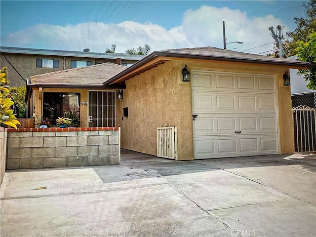 791 W 2nd St, San Pedro, CA 90731 - rear view of property with stucco siding and concrete driveway