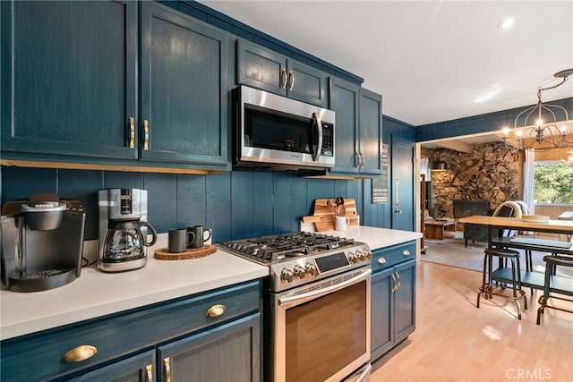 27979 N Bay Rd, Lake Arrowhead, CA 92352 - kitchen featuring light countertops, light wood-style floors, a notable chandelier, and stainless steel appliances
