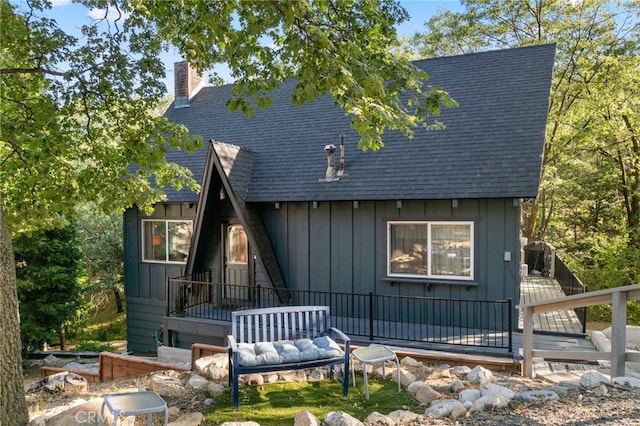 27979 N Bay Rd, Lake Arrowhead, CA 92352 - rear view of house with board and batten siding, a shingled roof, and a chimney
