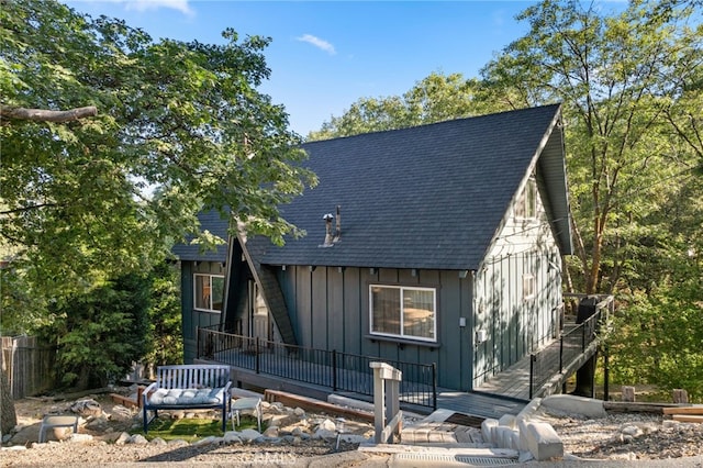 27979 N Bay Rd, Lake Arrowhead, CA 92352 - a-frame home featuring board and batten siding, a shingled roof, and fence