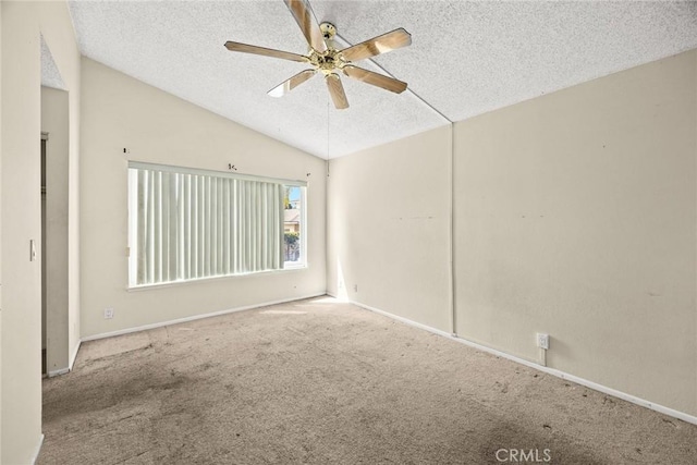 unfurnished room with a textured ceiling, baseboards, carpet, lofted ceiling, and ceiling fan