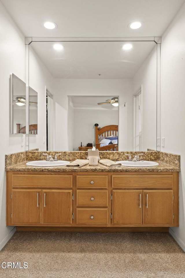 full bathroom featuring carpet flooring, a sink, and double vanity