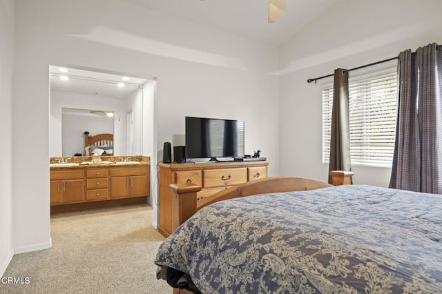 bedroom featuring vaulted ceiling, connected bathroom, ceiling fan, light colored carpet, and baseboards