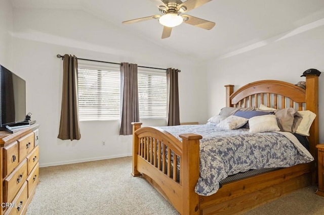 bedroom with lofted ceiling, a ceiling fan, baseboards, and light carpet